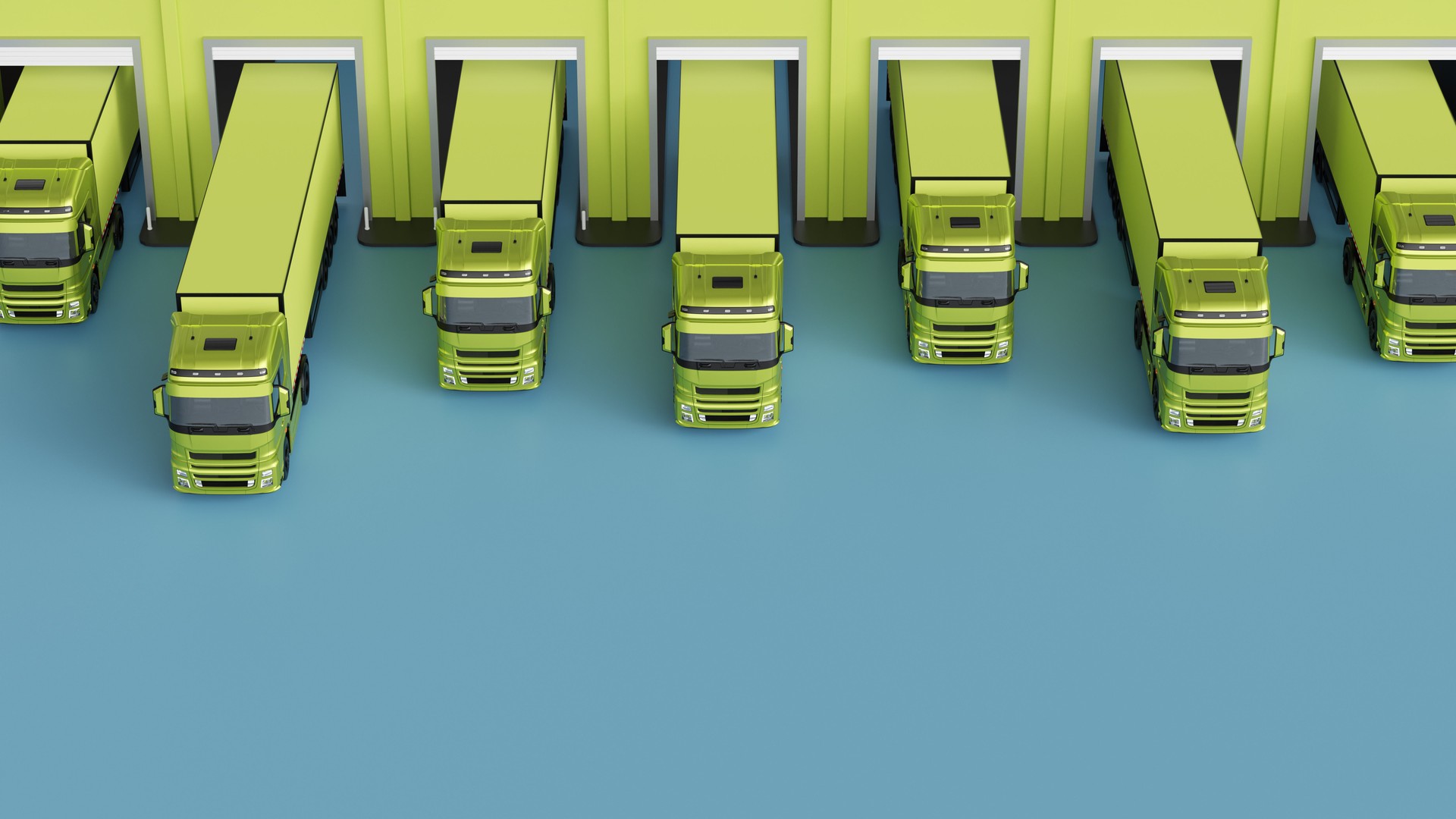 Aerial view of green semi-trucks at the warehouse. Freight transportation and storage concept.